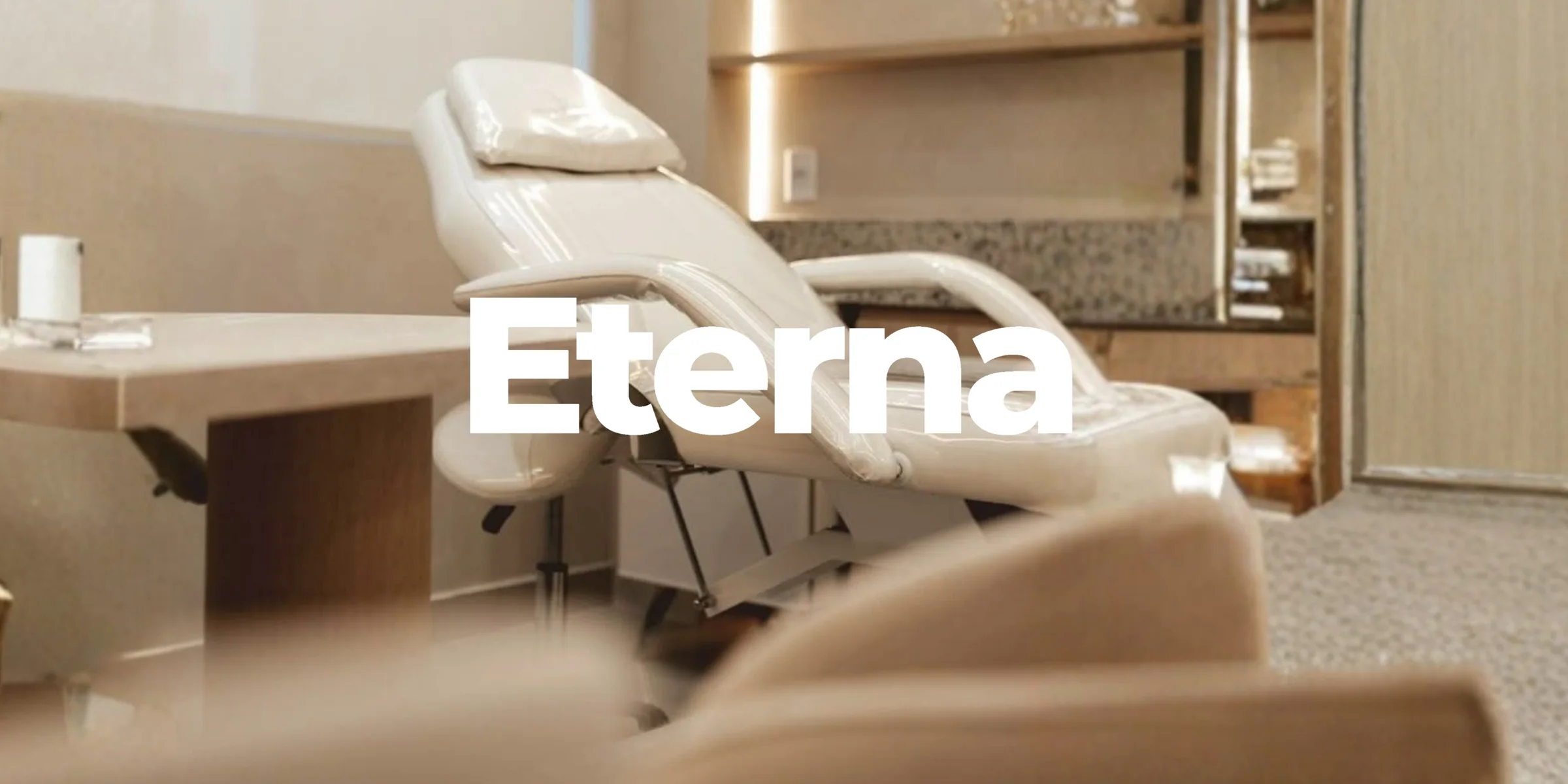 The Eterna treatment room interior, with the Eterna wordmark overlaid on the reclined treatment chair.